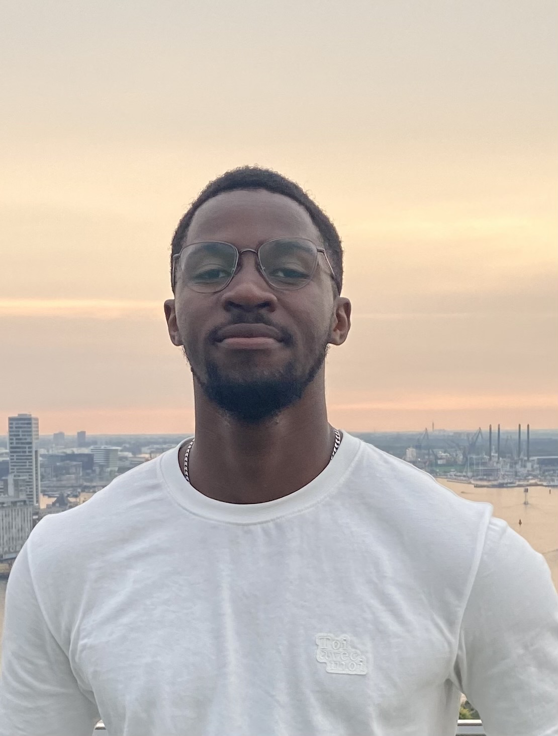 URIEL SAMBIANI standing in front of city skyline